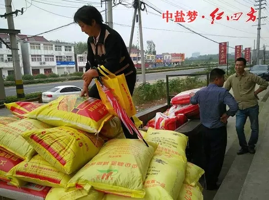 農(nóng)戶拿著紅四方贈送的小禮品，樂滋滋地開著裝滿紅四方肥料的拖拉機準(zhǔn)備回家